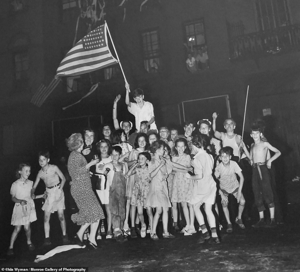 Children are caught celebrating the unconditional surrender of  Imperial Japan on VJ-Day in Times Square on August 14, 1945. Though Wyman detested the term 'street photography,' it characterizes much of her work. 'Life was in the streets,' she said. 'That's where you were. Nobody thought of it as street photography'.