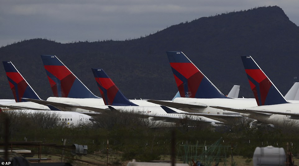 Tail fins of passenger planes, mostly Delta Air Lines planes, sit parked at Pinal Airpark