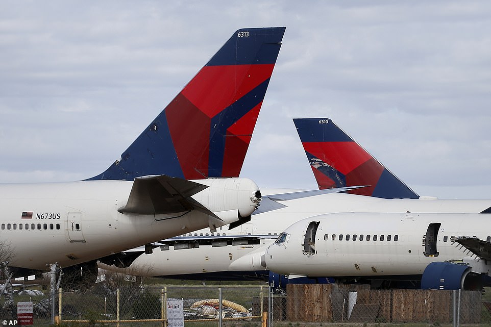 Mothballed Delta Air Lines passenger planes are joined by recently arrived Delta airplanes at Pinal Airpark