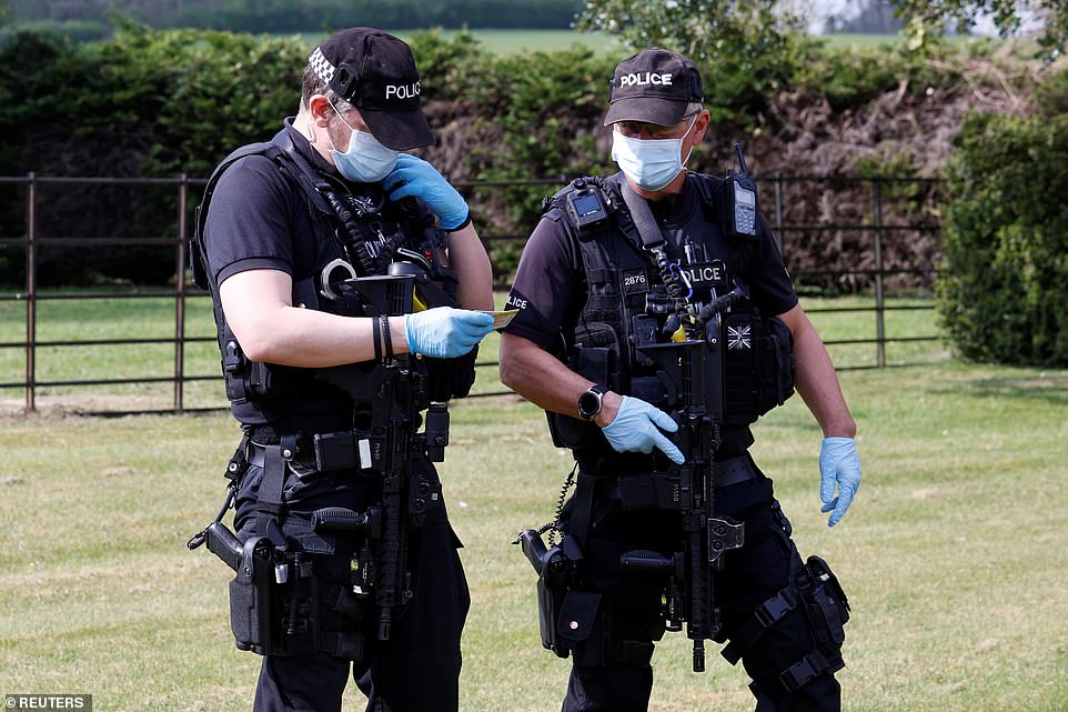 Police officers wearing gloves and masks on patrol outside Chequers in Buckinghamshire today ahead of the Prime Minister's arrival