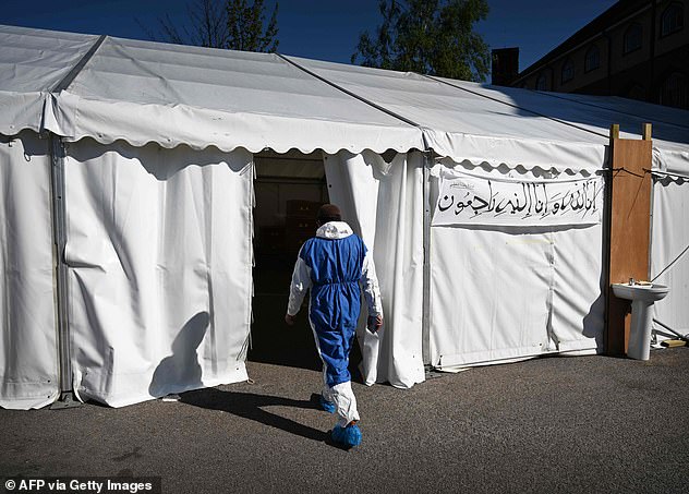 A member of staff enters the temporary mortuary which was constructed three weeks ago