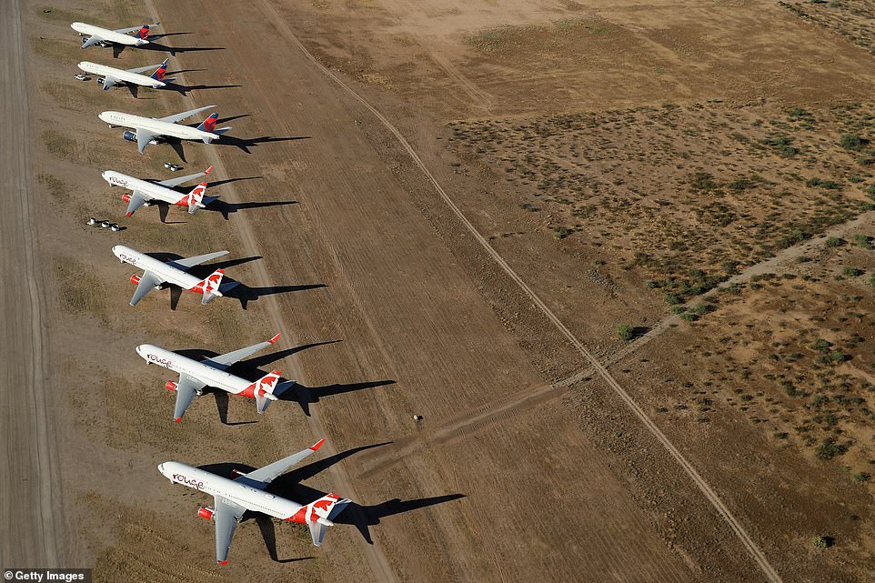 Large Air Canada Rouge planes sit at Pinal Airpark where they will remain while the coronavirus pandemic puts most of the world's foreign travel on hold