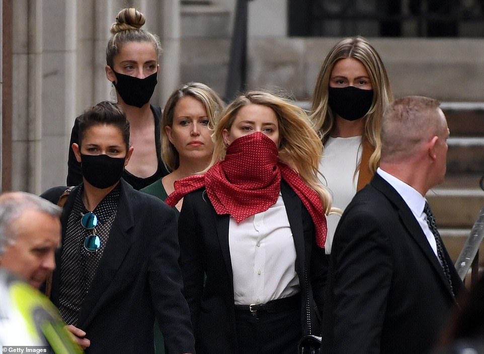 Heard leaving the High Court in London with 'Team Heard', including her girlfriend Bianca Butti (front left)