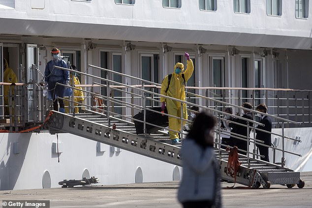 Prior to today's announcement, the cruise industry had gone to great lengths to make ships as safe as possible in the hope of opening up again. Pictured: Crew members leave an Australian-owned cruise ship in May