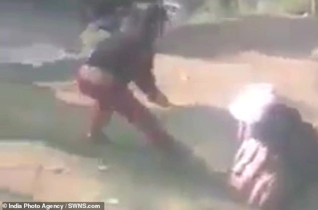 Ghulam Qadir Sheikh , 55, (pictured right, with the bear) was the subject of an unprovoked attack by the bear and needed a passer-by (left) to beat the animal with a stick to help him break free