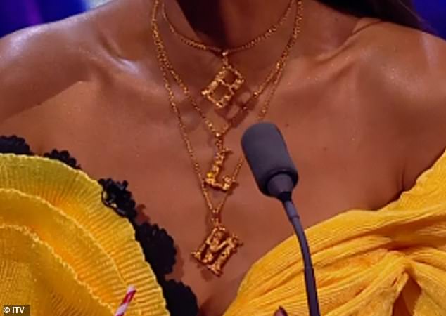 Proud: The Miss-Teeq star appeared in the off-shoulder yellow ensemble featuring a ruffle hem but all eyes were on her statement necklace