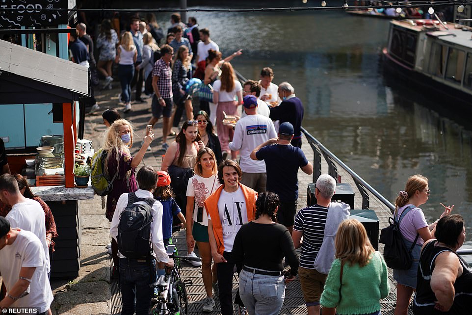 Covid sufferers could be fined up to £10,000 if they leave their house when they are meant to be self-isolating under draconian new rules being introduced by Boris Johnson. Pictured: People visit Stables Market in Camden, London, earlier today