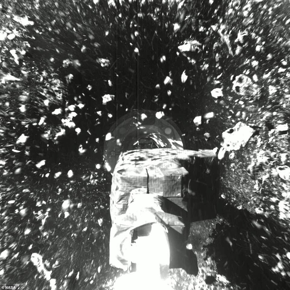 A nitrogen gas bottle then fired on the surface to kick up material like rocks and dust and suck it up in a 'rubble shower'. The crushed rocks and dust pictured floating in the air