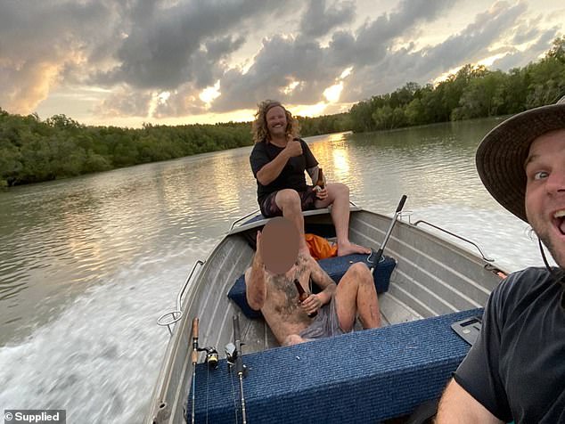 Kev Joiner (centre) and Cam Faust (right) pictured with Voskresensky after finding him in the mangroves