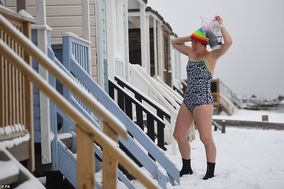 Early morning swimmers take a dip in the water, which is 1.4C, at Thorpe End, Essex