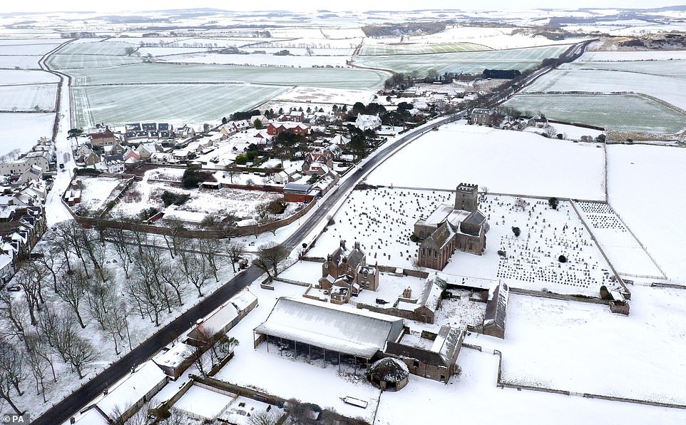 Snowy fields around St Aidan's Church, Bamburgh in Northumberland. Temperatures will widely be below freezing overnight across the country and in low single figures in the daytime on Tuesday and Wednesday, the Met Office says