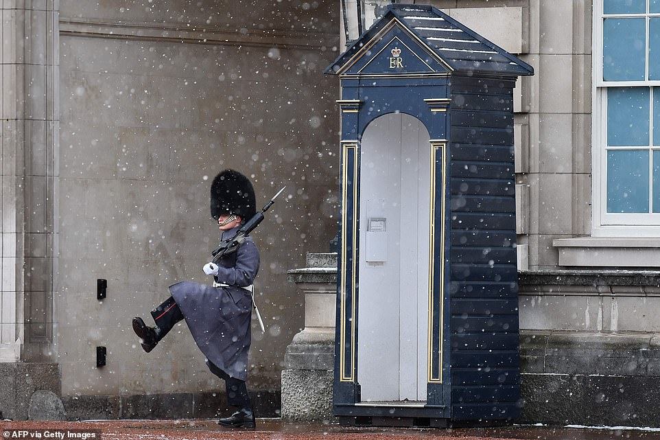 A Sentry of the Scot's Guards stands on duty in the snow outside Buckingham Place