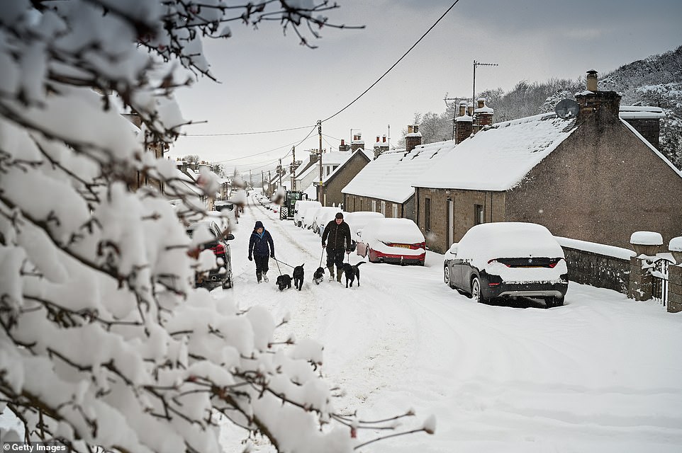 Families enjoyed a snowy walk in Dunning, Scotland. A further warning for tomorrow and into Friday morning covers the North East coast, from eastern Scotland to the Yorkshire Wolds, where up to 8cm (3.2ins) of snow could fall