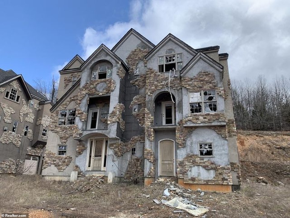 With their smashed windows and busted doors, the McMansions at the failed Indian Ridge Resort have become an eyesore