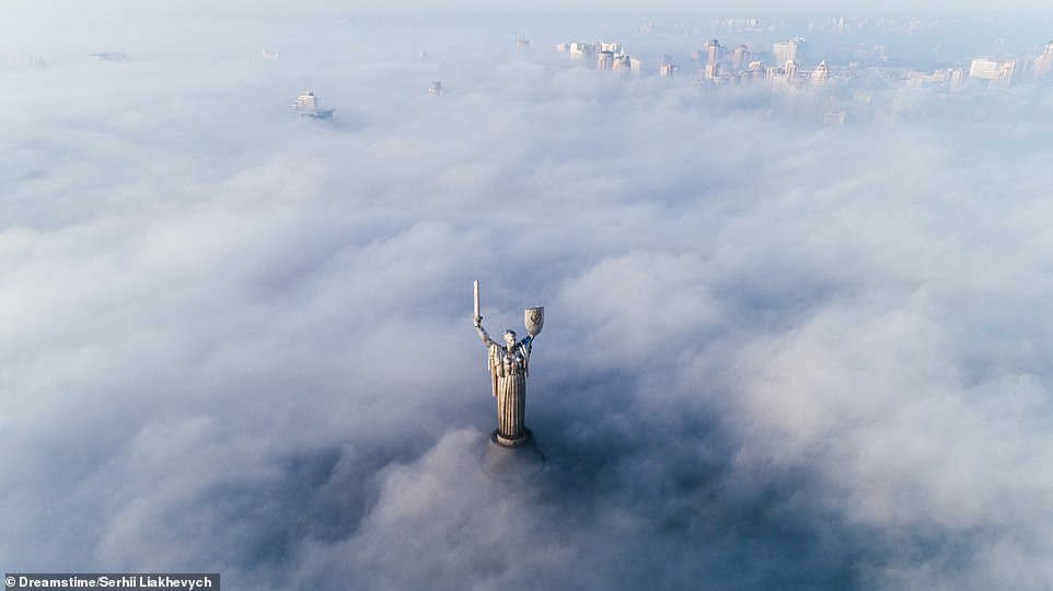 THICK FOG, MOTHERLAND MONUMENT, KIEV, UKRAINE: 'There are a number of ways that the water vapour that forms fog can be added to the air,' Ford writes. 'These include precipitation falling from the clouds; water evaporating from the surface of bodies of water or wet land during the heat of the day; winds converging into updrafts; cool or dry air moving over warmer water; air that hits and then rises over mountains; and transpiration from plants'