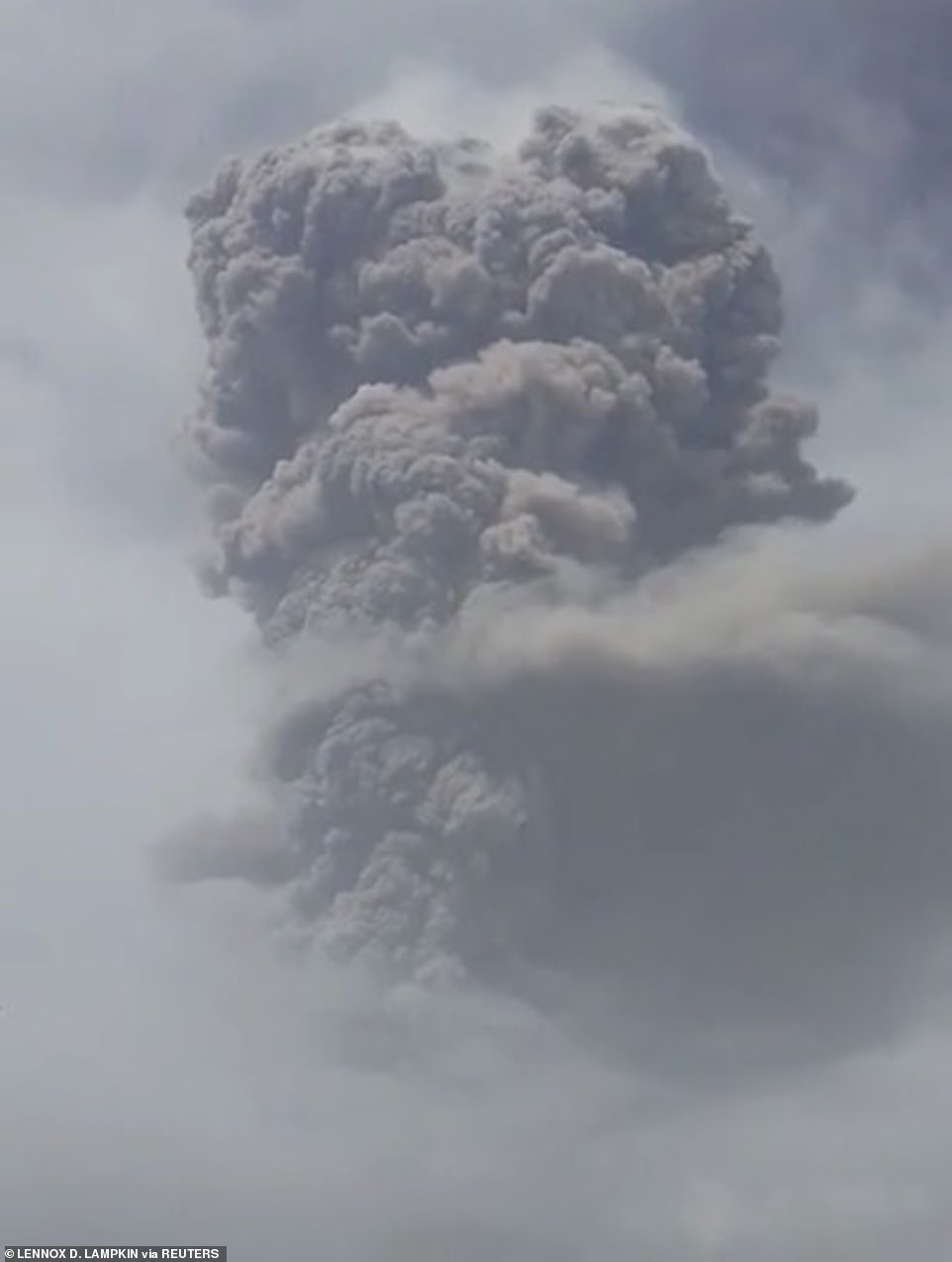 Experts have warned that explosive eruptions could continue for days, or possibly weeks, and emergency aid supplies, such as cots, tents and respirator masks, have poured in from neighbouring nations. Pictured: A plume of ash is seen rising in the sky following the volcanic eruption
