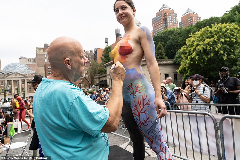 This woman smiles as the paintbrush appeared to gently tickle her as the paint was pasted on