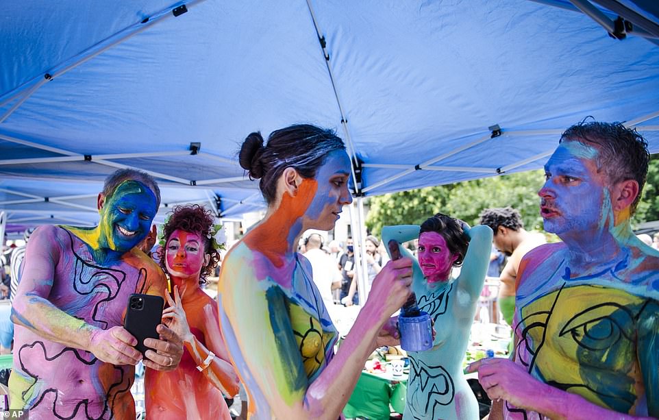 Models take selfies and chat while painting one another at Human Connection Arts 8th Annual NYC Bodypainting Day