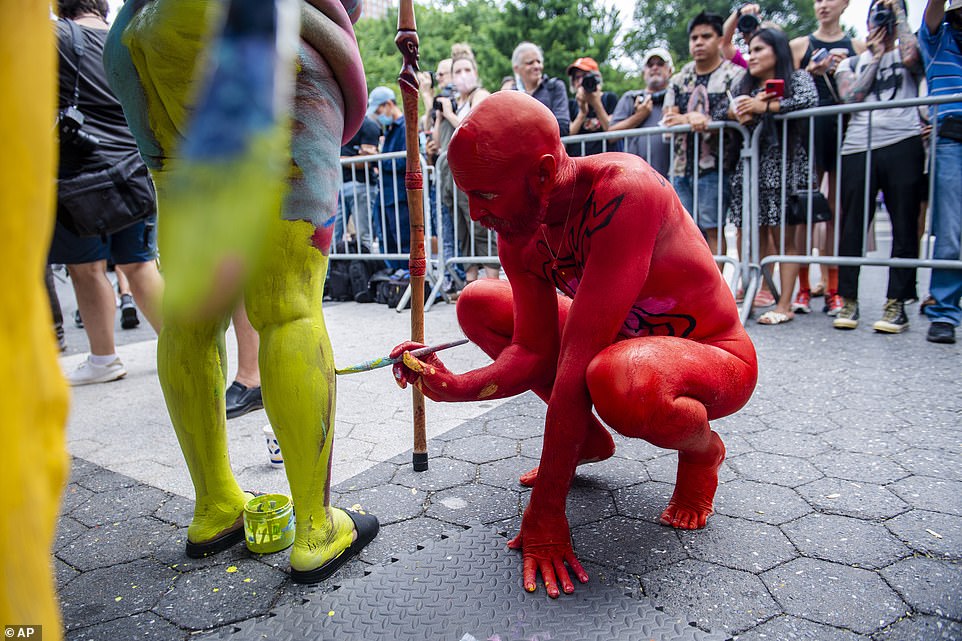 Bo Attwood paints the legs of Lakisha 'KiKi' Alston at Human Connection Arts 8th Annual NYC Bodypainting Day