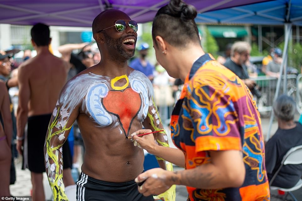 One man laughs as the tickley paintbrush decorated his abs