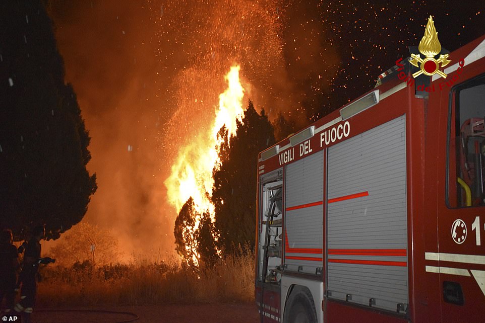 Italian firefighters race to a wildfire near Petralia Soprana, near Palermo, Sicily, as mercury levels rise