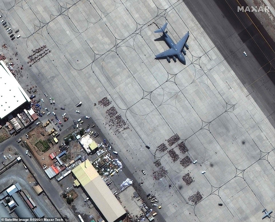 The US said some 16,000 people were flown out of Kabul between Sunday morning and Monday afternoon, with thousands more due to leave the country today (pictured, a satellite image shows people boarding a military plane)