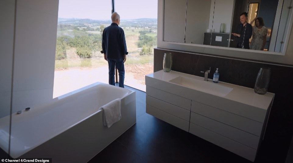 Meanwhile windows made from enormous panels of glass offered incredible views of the Devon countryside from each room (pictured, Kevin in the bathroom)