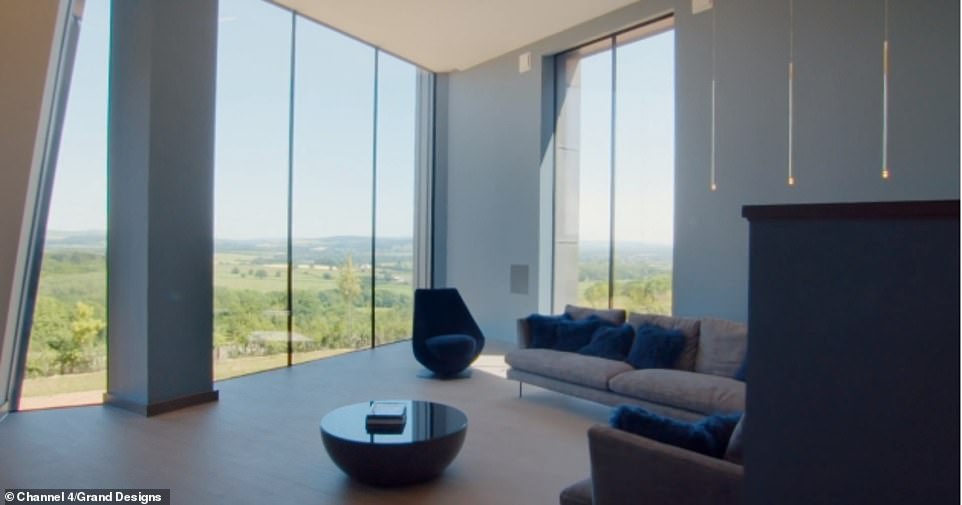The couple said solar panels would help power the interior and the home was filled with gadgets, including facial recognition and intelligent heating (pictured, the living room)
