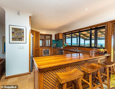 A timber kitchen take up one side of the ground floor