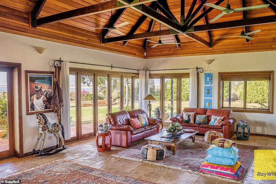 The house features a living room with vaulted timber ceilings inspired by a cathedral and a north-facing verandah that captures stunning sunset views