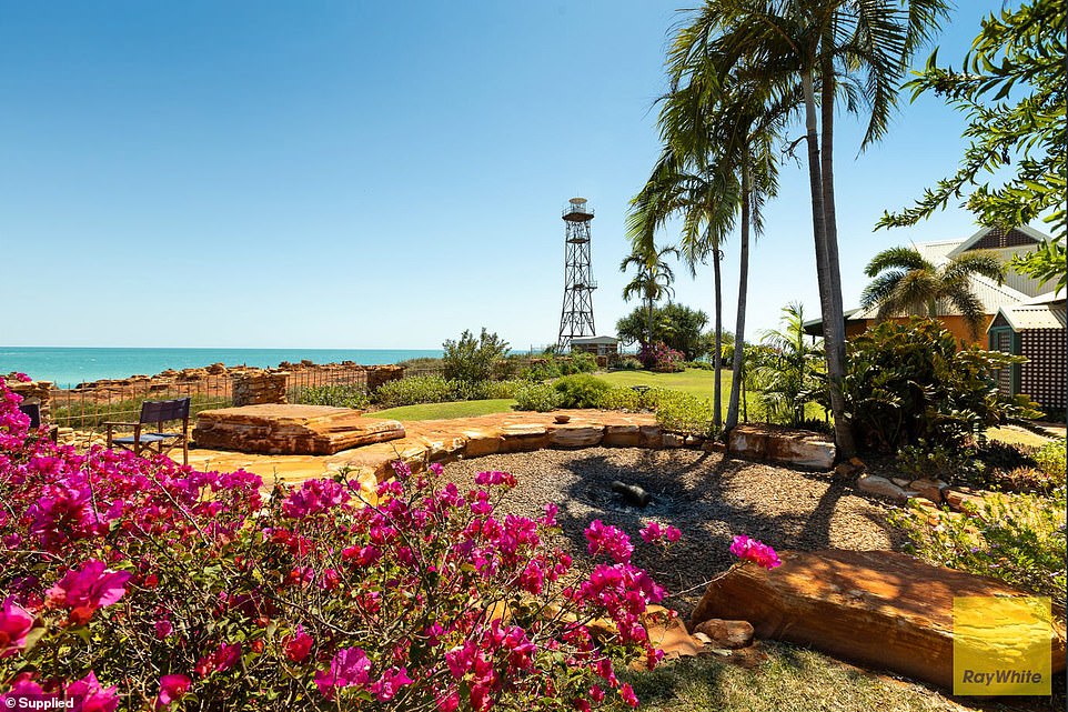 The garden includes a sun terrace and an enormous firepit (pictured)