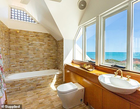 The house has three bathrooms, one with a large spa tub