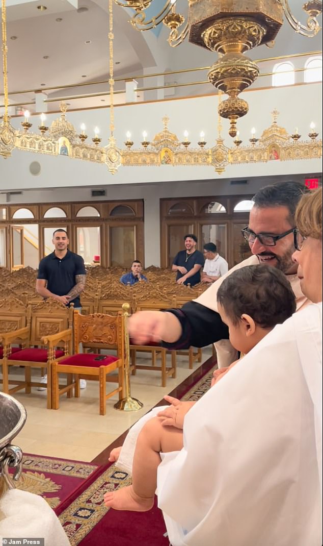 Father Demetri described the scene as 'surreal', saying it was 'like a mini exorcist episode' as it happened as the priest held the baby up to the holy water