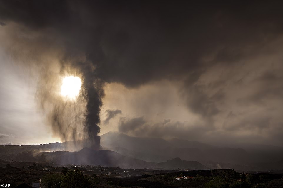 A thick plume of smoke and ash is seen rising into the sky from the volcano, which has now entered a 'new phase' of its eruption, according to scientists studying it