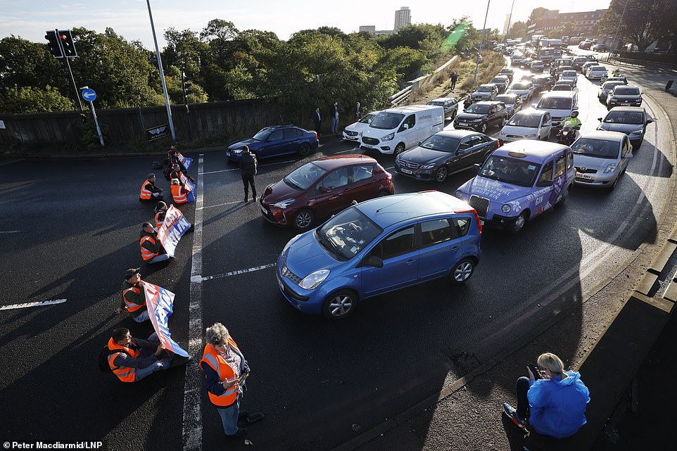 Activists from Insulate Britain climate change protest group block the Hanger Lane gyratory on the A40 junction