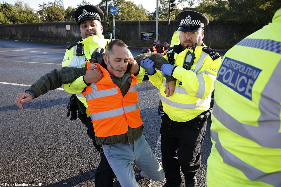 Police detain activists from Insulate Britain climate change protest group as they block the Hanger Lane gyratory