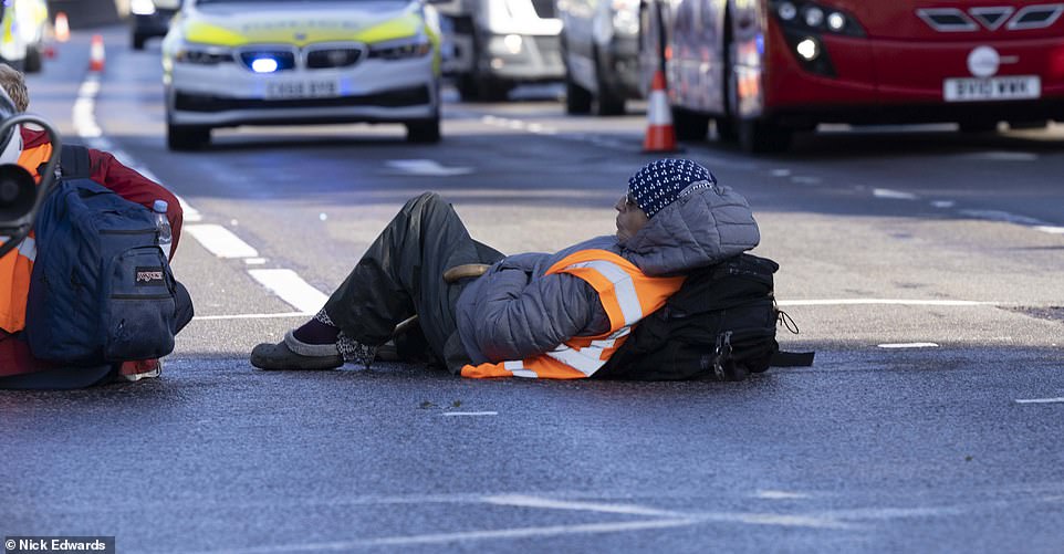 Insulate Britain protesters sitting on the side of the A12, Poplar, leading to the Blackwall Tunnel
