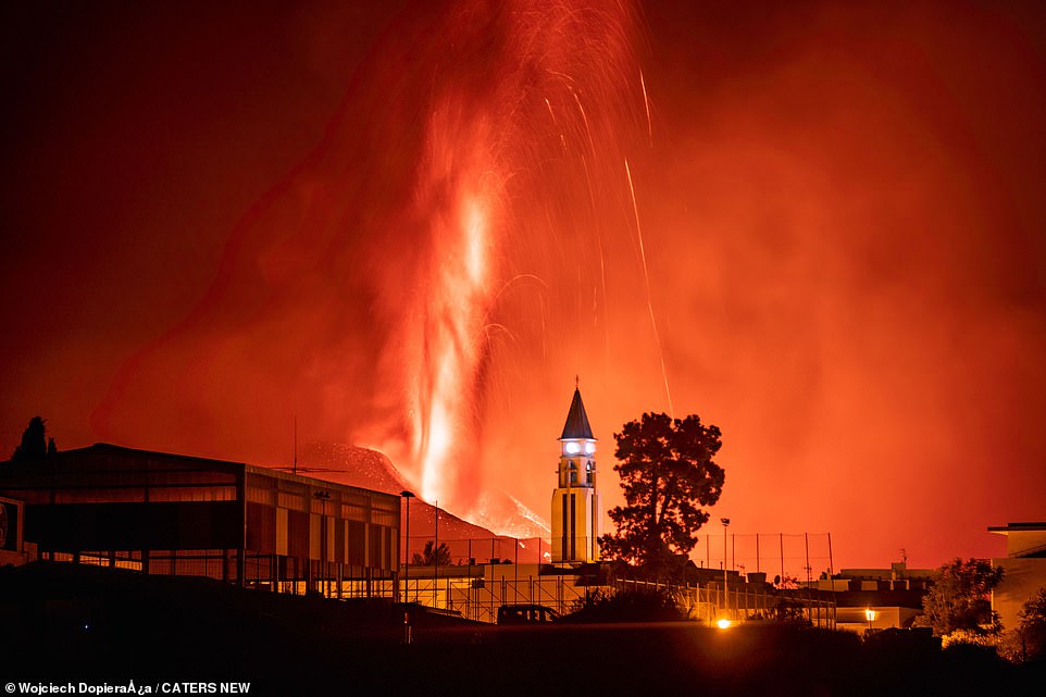 The volcano emitted a loud booming noise and lava exploded with force from its crater as it spurted high above the Spanish island