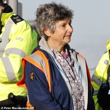 TODAY: An Insulate Britain protester being arrested by police for blocking Hanger Lane