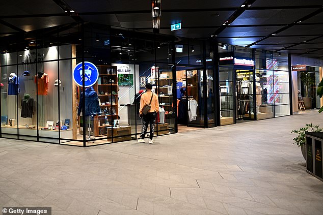 Nine new cases in a country where 93 per cent of the population is now double vaccinated — but nine cases too many for our Left-wing Prime Minister Jacinda Ardern, committed as she apparently is to a policy of 'Zero Covid' at any cost. Pictured: A member of the public looks through a shop window in Auckland