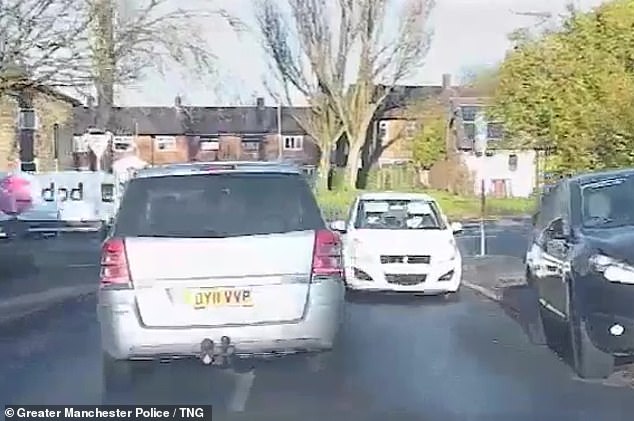 Ghalib ignores a 'give way' sign and drives directly at oncoming traffic in Newcliffe Road, Greater Manchester, during the police pursuit